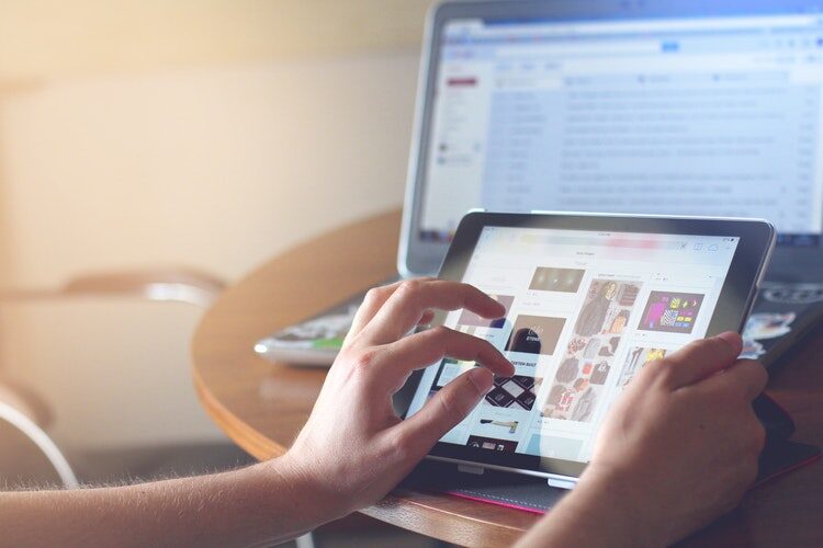 Person working on a tablet while configuring SharePoint Online remote event receiver settings